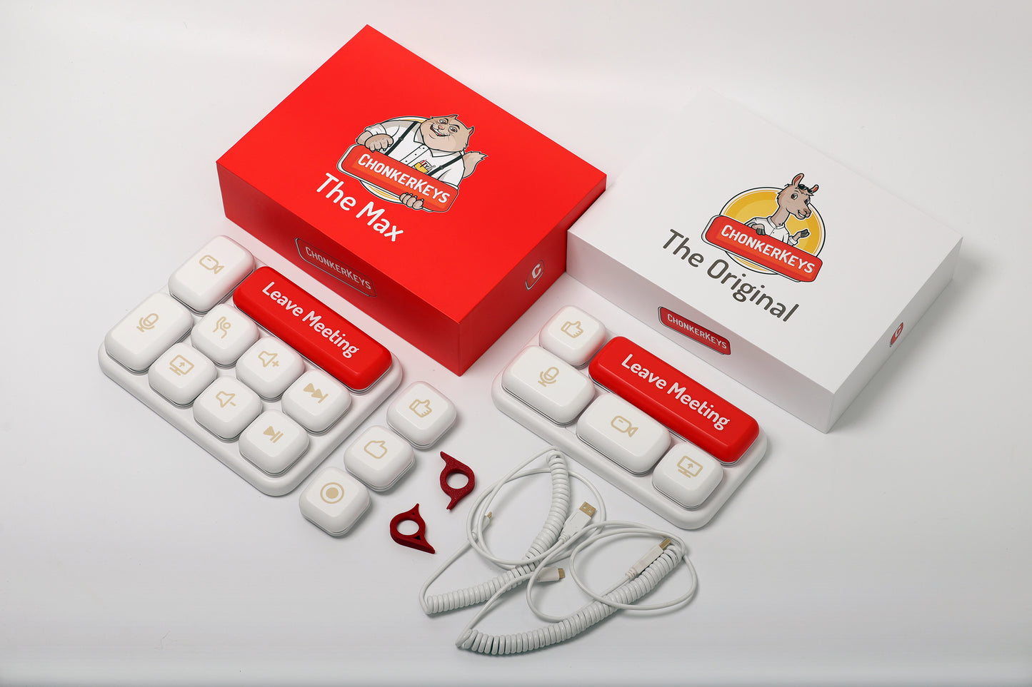 The box package and the contents of The Max and The Original, showing the two units, three extra buttons (record, speech bubble, thumbs up), two key changing tools, two coiled USB type-c cables